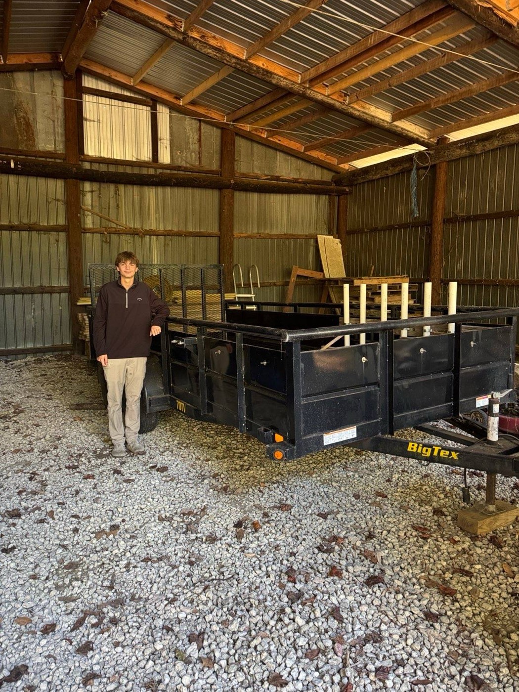Crew member standing beside the trailer for scale